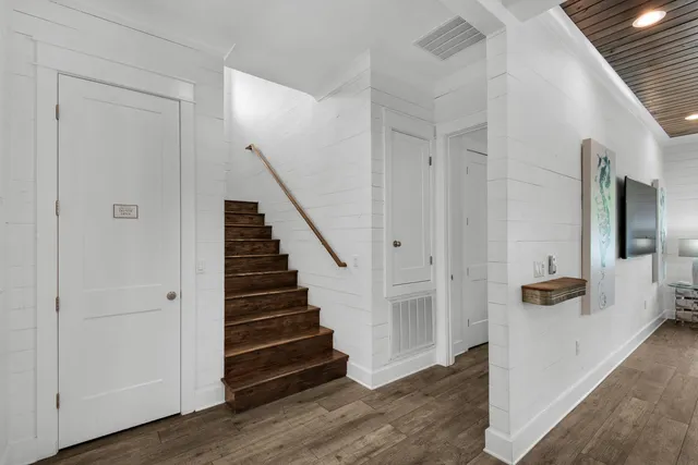 a bedroom with a large bed chandelier and a window