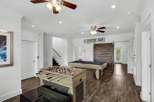 a view of a livingroom with wooden floor and a flat screen tv