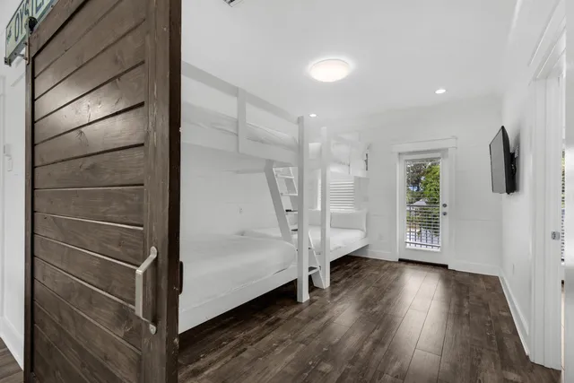 a bedroom with a large bed and a flat screen tv