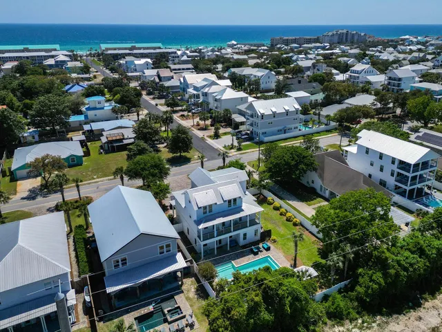an aerial view of multiple houses with yard