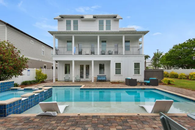 an aerial view of a house with swimming pool garden and patio