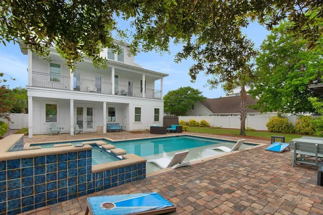 an aerial view of a house with swimming pool garden and patio