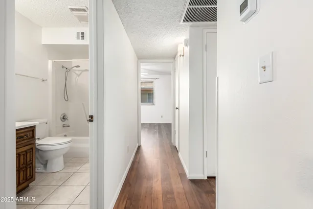 a bathroom with a toilet and a shower