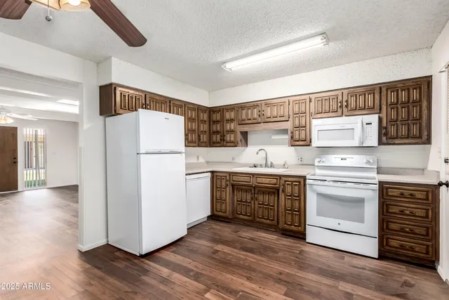 a kitchen with a refrigerator sink and stove