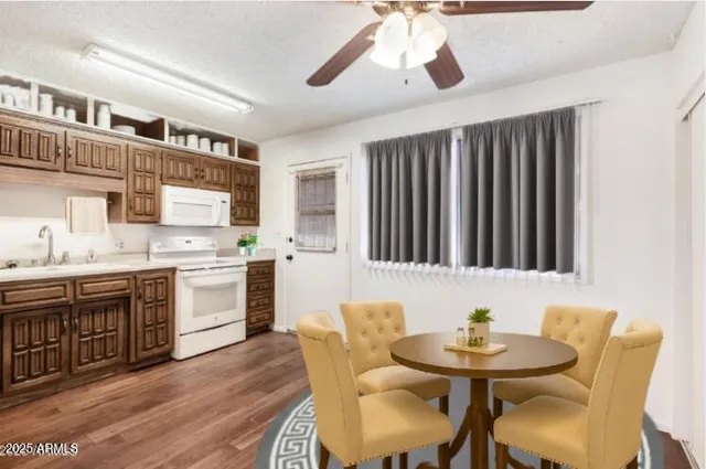 a kitchen with stainless steel appliances kitchen island granite countertop a sink and cabinets