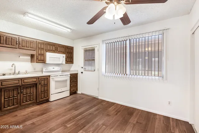 a open kitchen with a sink cabinets stainless steel appliances and a window