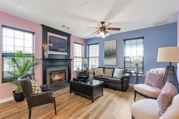 a living room with furniture a fireplace with wooden floor