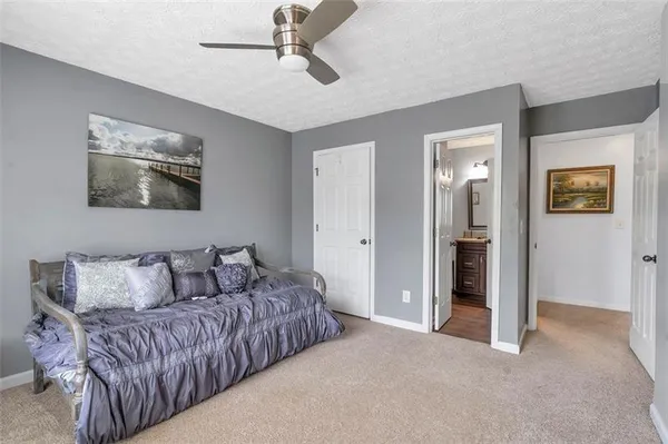 a living room with furniture and a ceiling fan