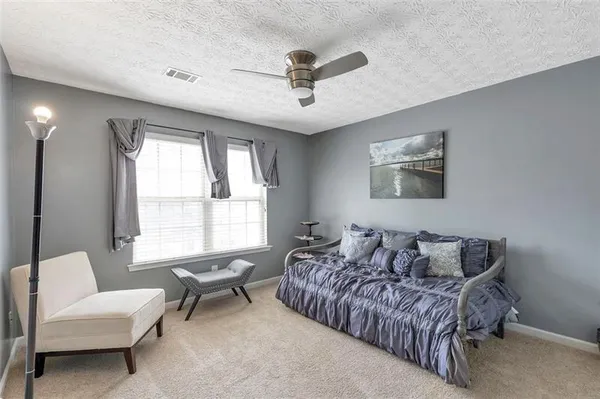 a bedroom with a bed and a couch