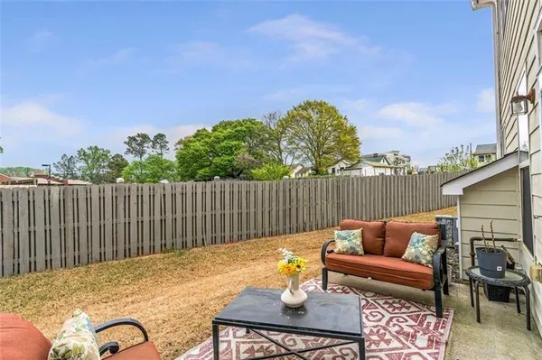 a view of a house with backyard and sitting area