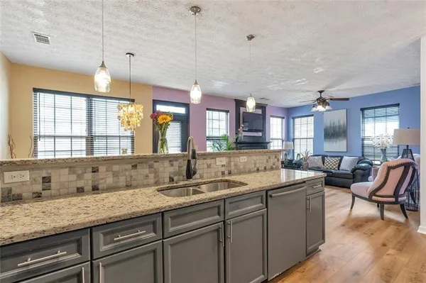 a bathroom with a granite countertop sink and a large mirror
