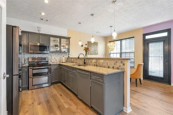 a kitchen with a sink stove and refrigerator