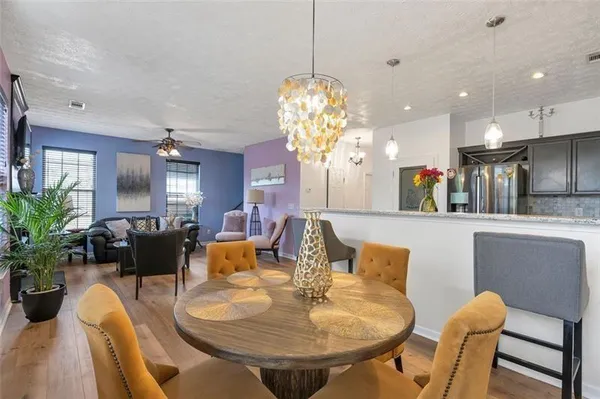 a dining room with furniture and a chandelier