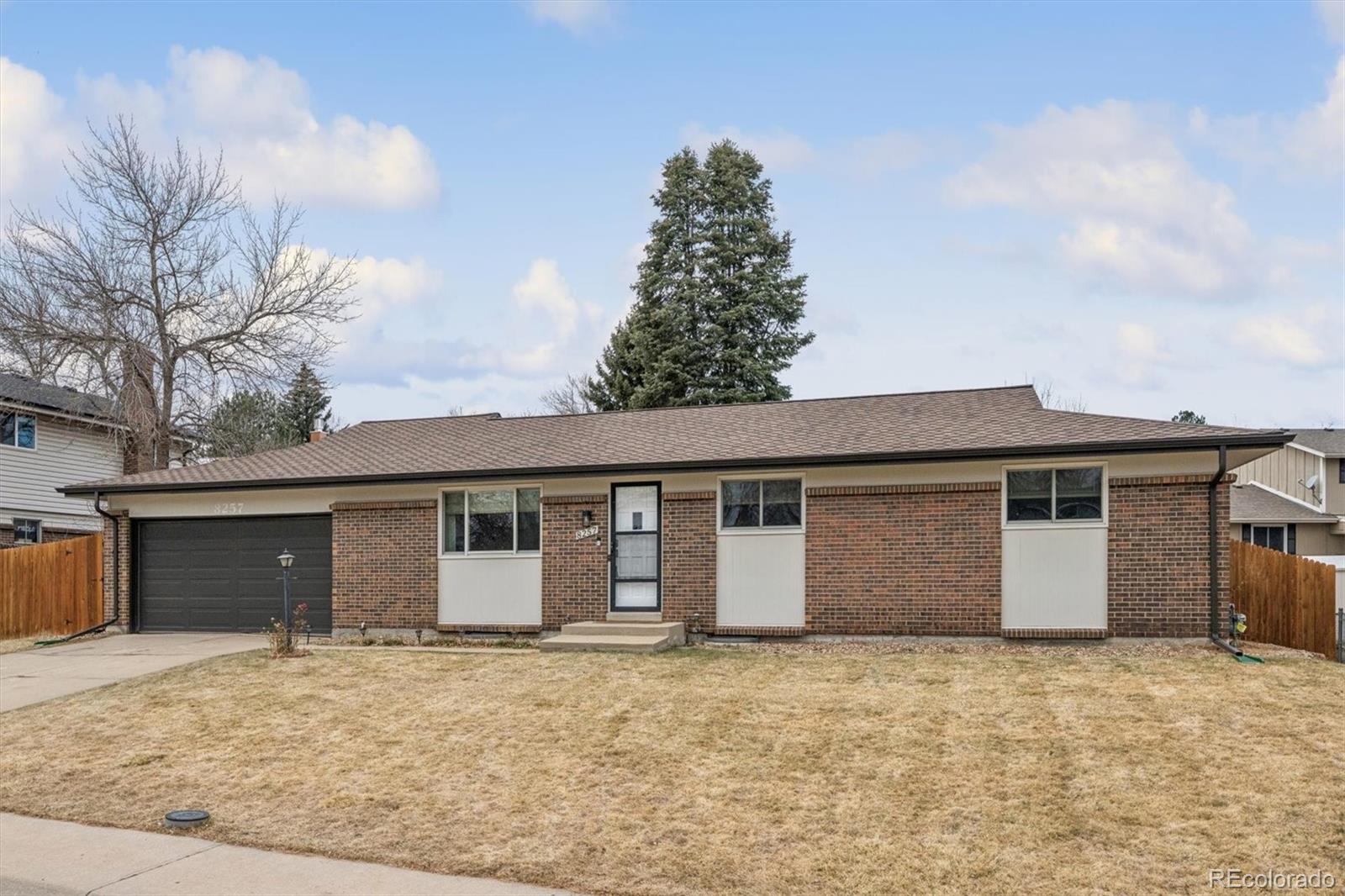 8257 Yarrow Court Arvada, CO 80005 - Photo 12 of 38 front view of house with a yard and garage