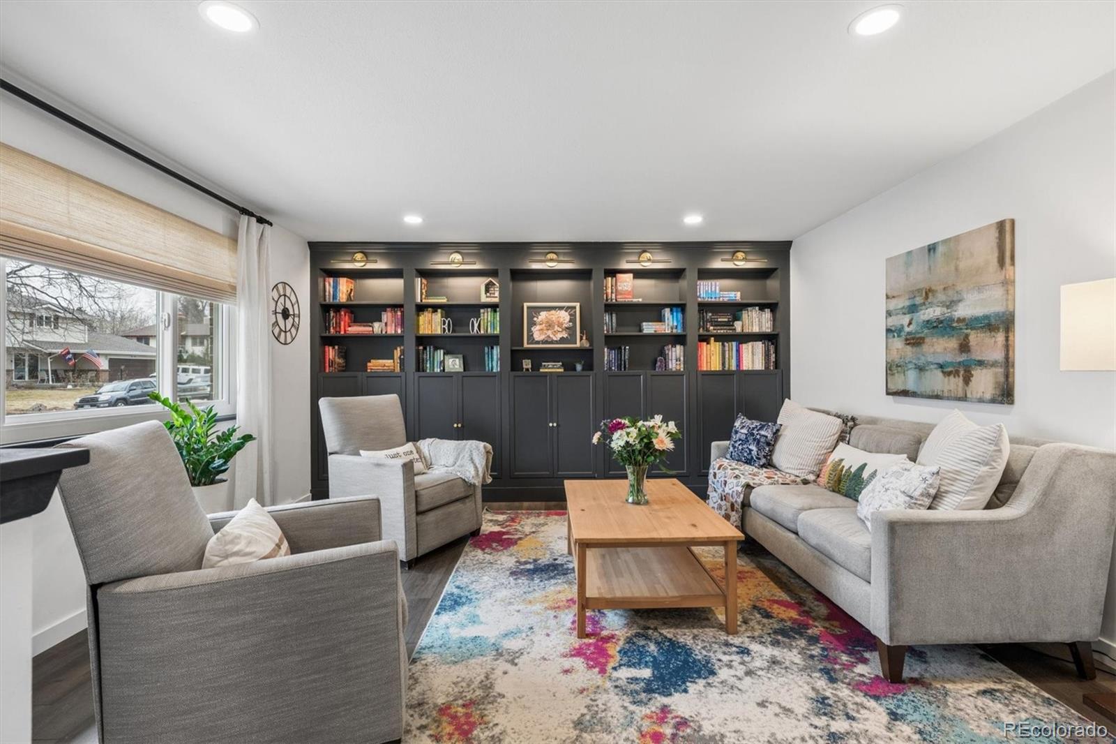8257 Yarrow Court Arvada, CO 80005 - Photo 13 of 38 a living room with furniture and a book shelf