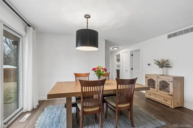 a view of a dining room with furniture wooden floor and a chandelier