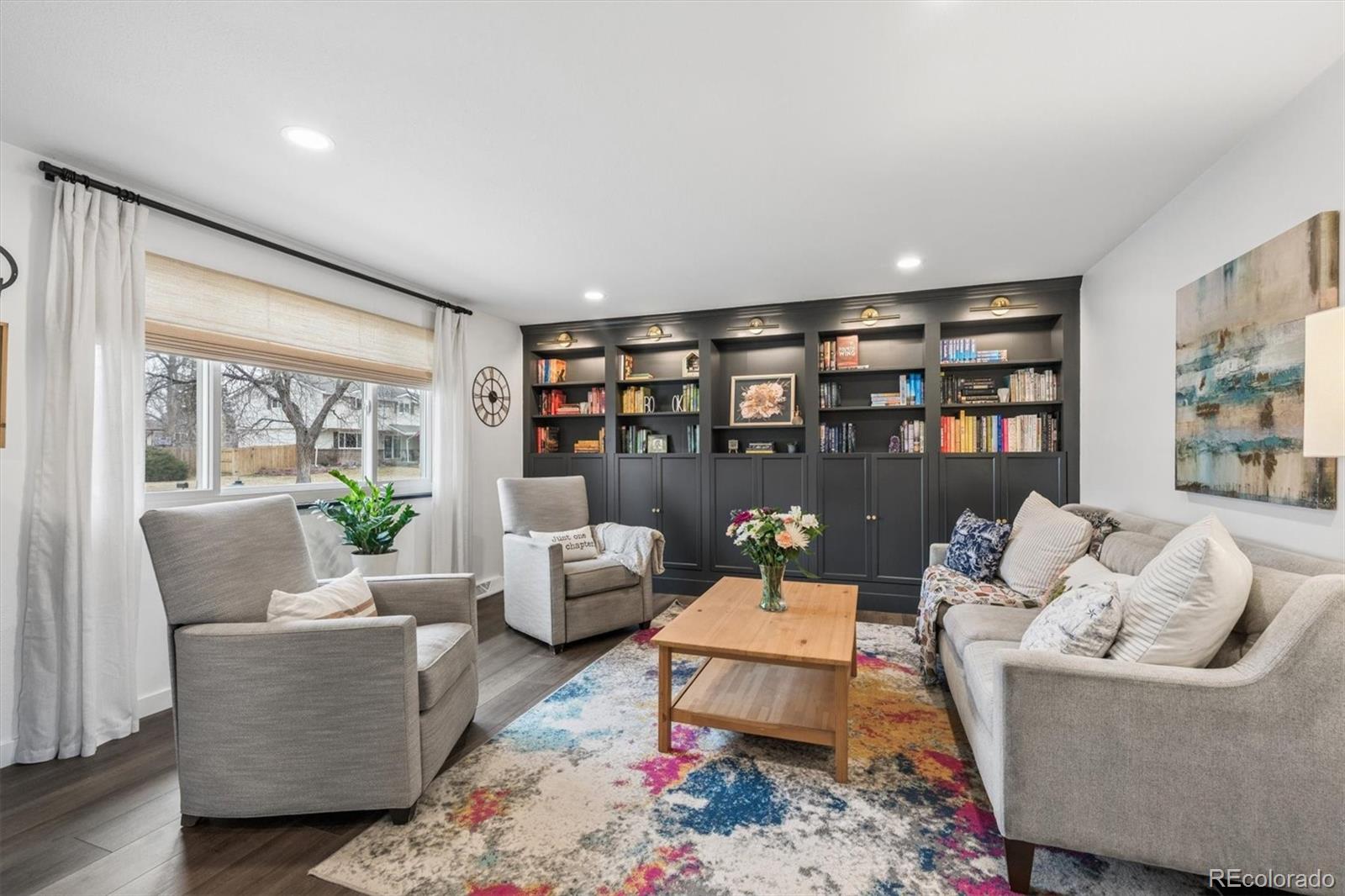 8257 Yarrow Court Arvada, CO 80005 - Photo 2 of 38 a living room with furniture and a book shelf