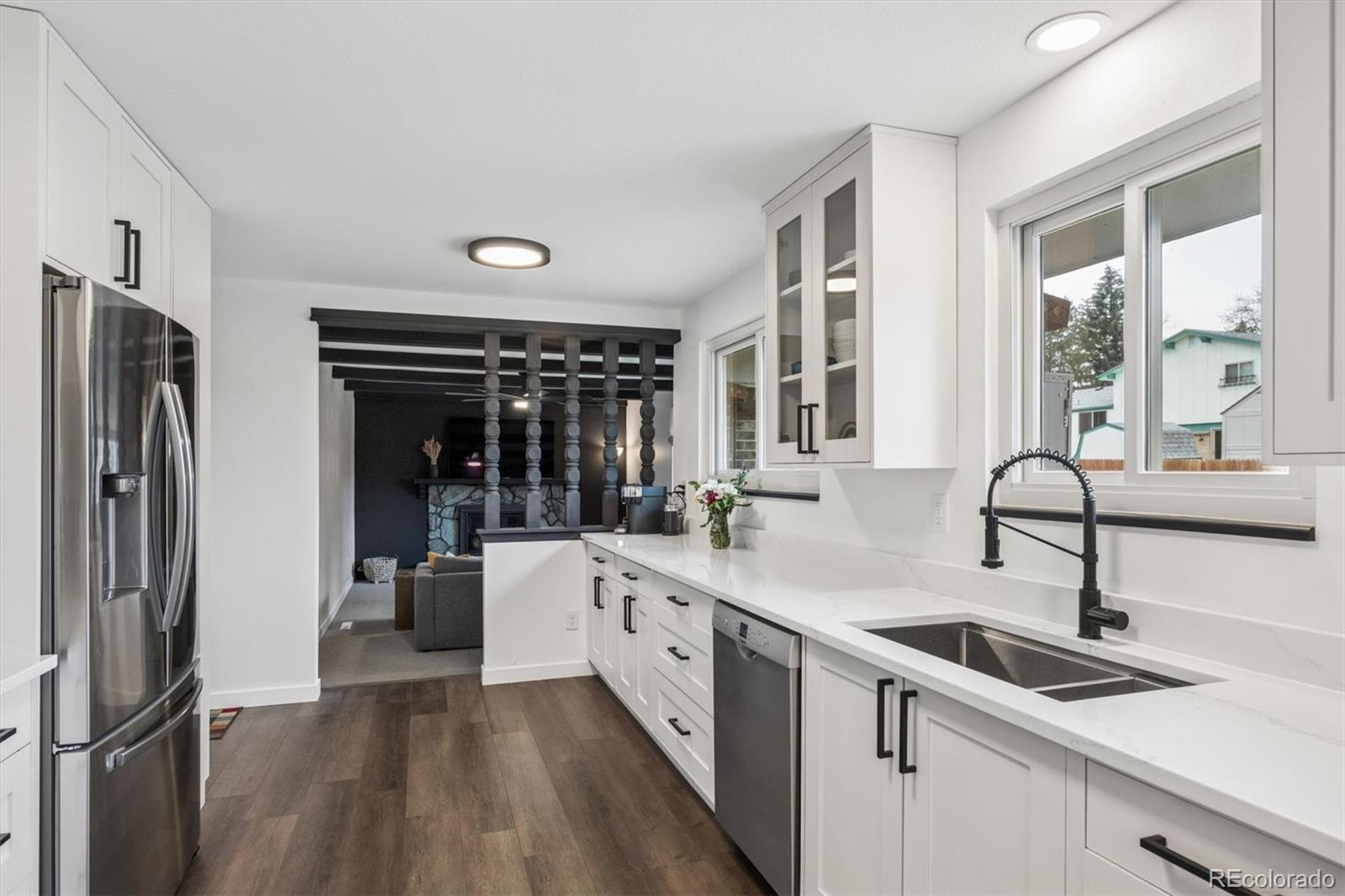8257 Yarrow Court Arvada, CO 80005 - Photo 22 of 38 a kitchen with a sink stove and refrigerator