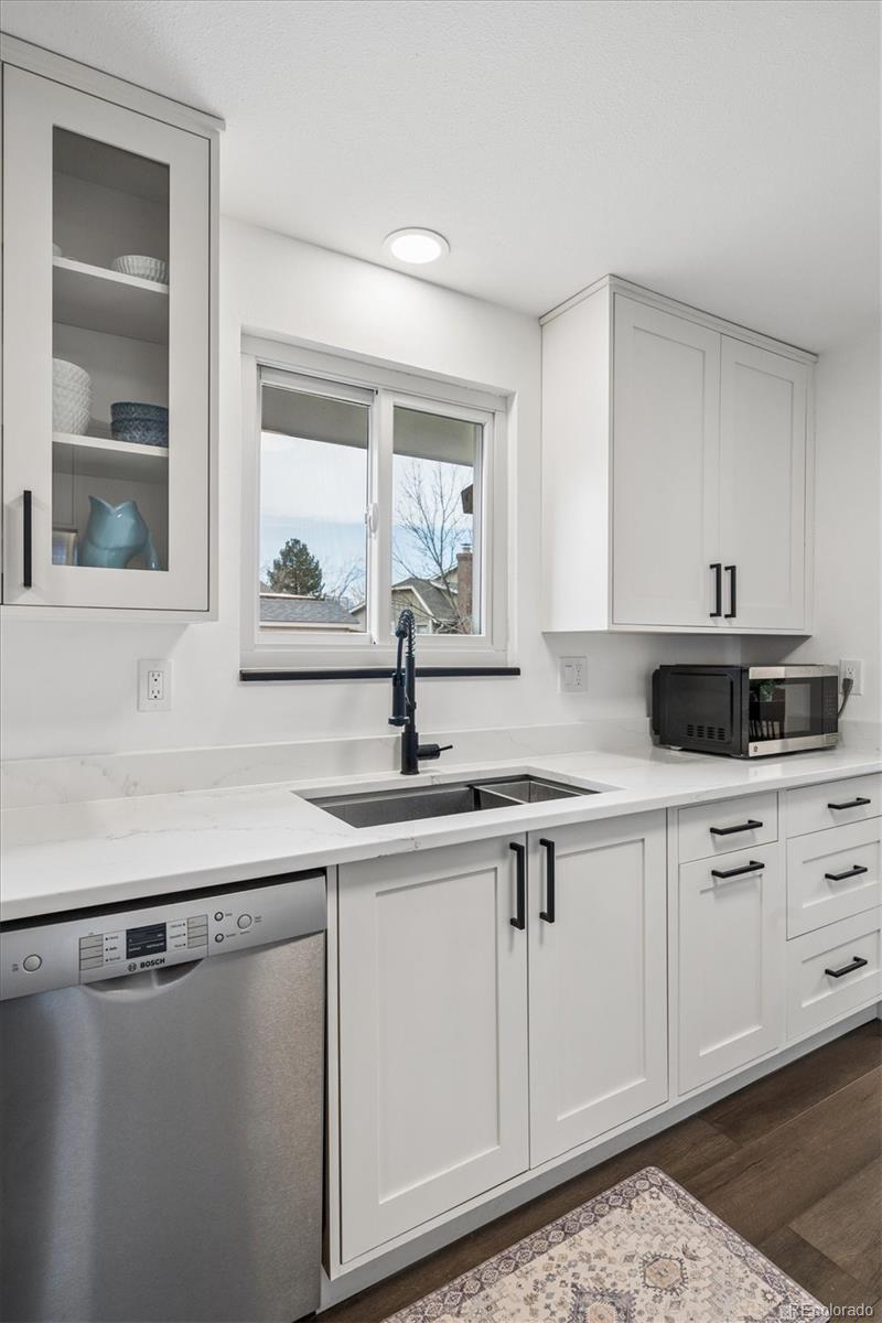 8257 Yarrow Court Arvada, CO 80005 - Photo 23 of 38 a kitchen with a sink cabinets and window