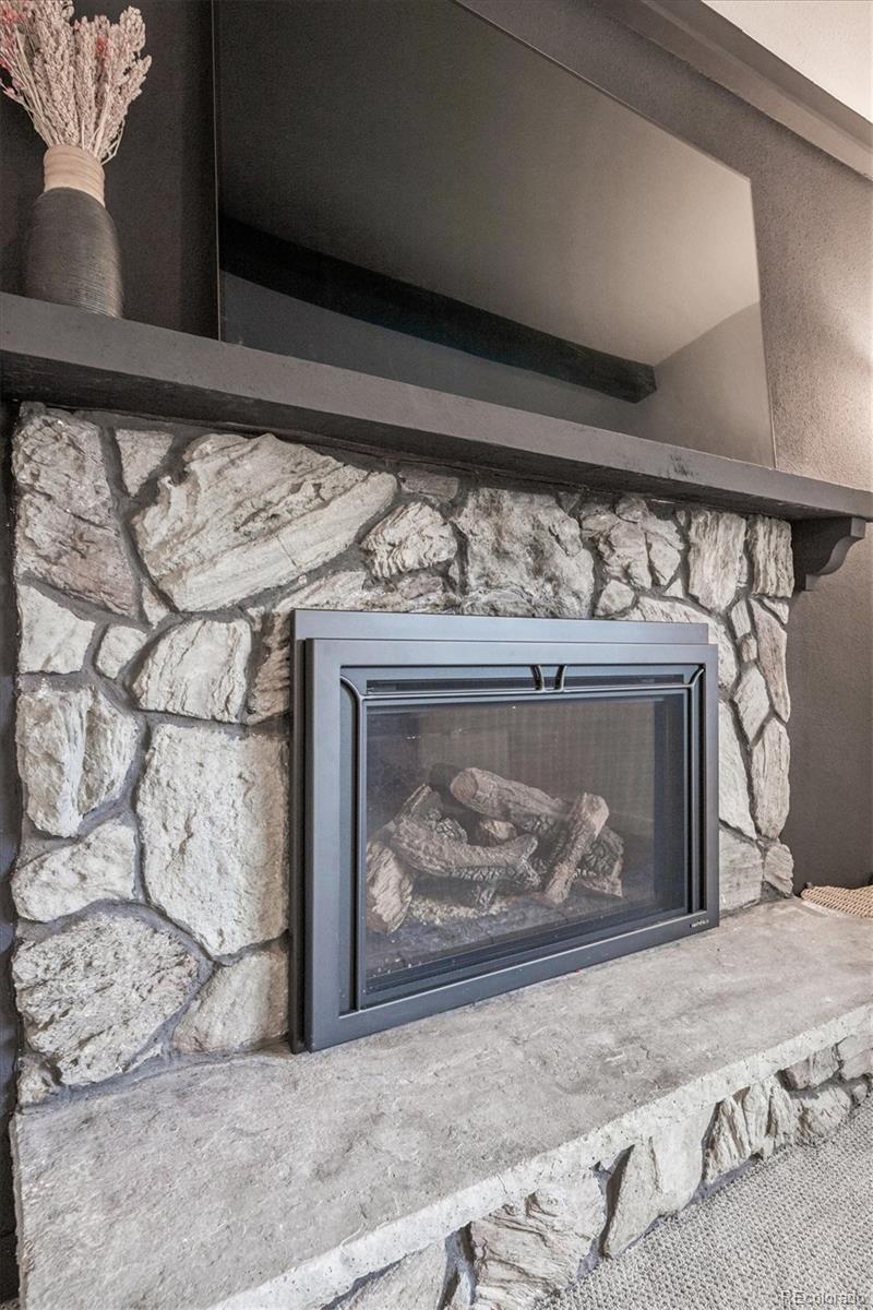 8257 Yarrow Court Arvada, CO 80005 - Photo 26 of 38 a bed with a fireplace