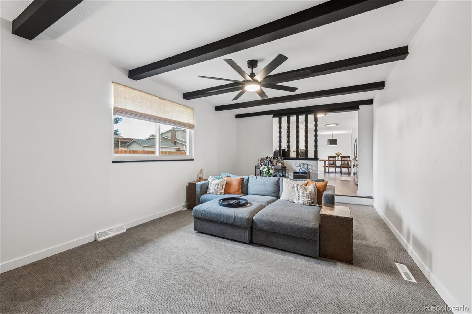 8257 Yarrow Court Arvada, CO 80005 - Photo 27 of 38 a living room with furniture and a large window