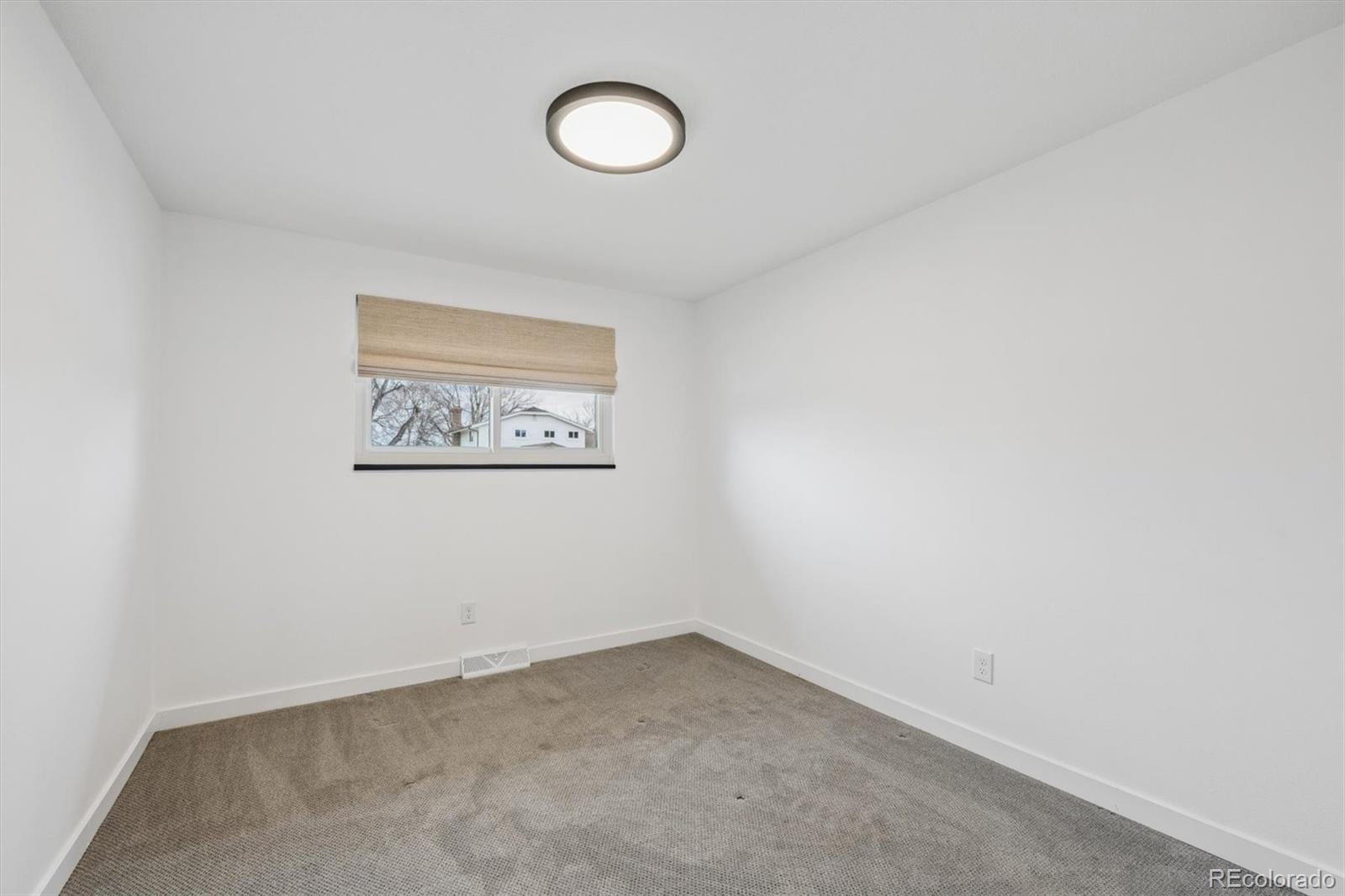 8257 Yarrow Court Arvada, CO 80005 - Photo 28 of 38 an empty room with a window