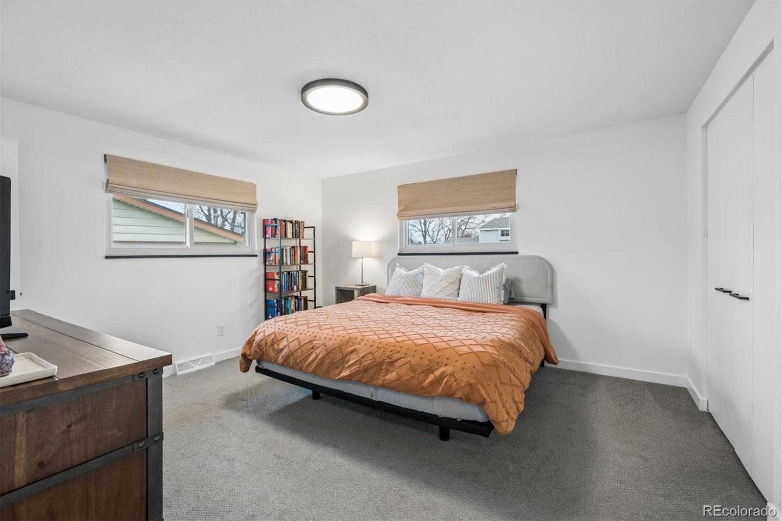 8257 Yarrow Court Arvada, CO 80005 - Photo 30 of 38 a bed sitting in a bedroom next to a window