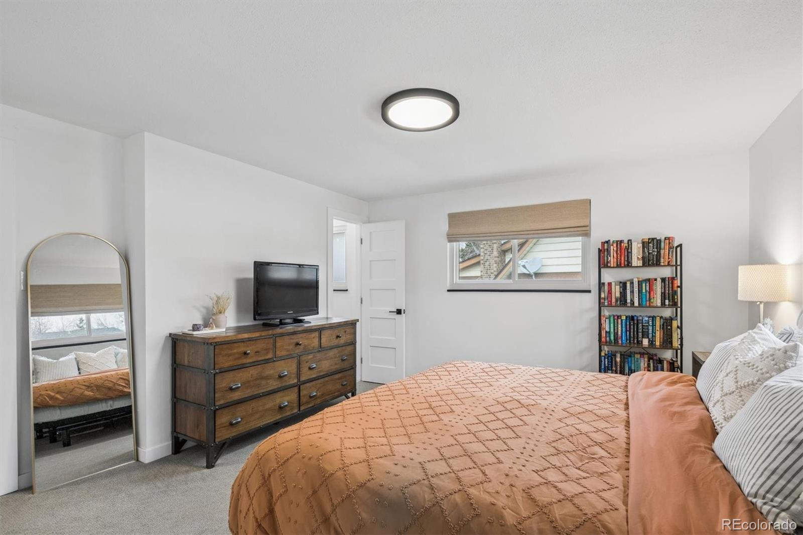 8257 Yarrow Court Arvada, CO 80005 - Photo 31 of 38 a bedroom with a bed and a television