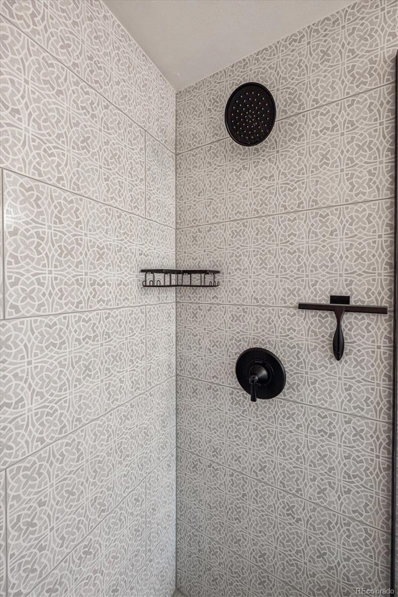 8257 Yarrow Court Arvada, CO 80005 - Photo 32 of 38 a bathroom with a shower