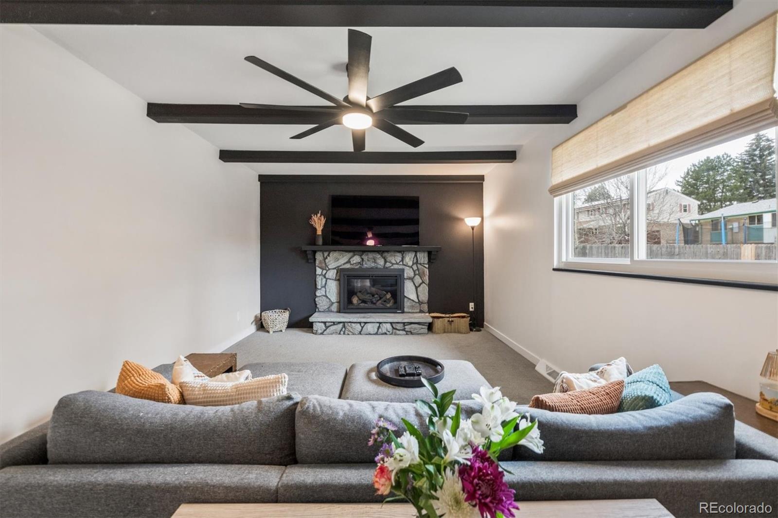 8257 Yarrow Court Arvada, CO 80005 - Photo 6 of 38 a living room with furniture and a fireplace