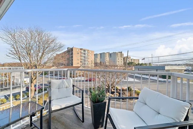a balcony with furniture and a potted plant
