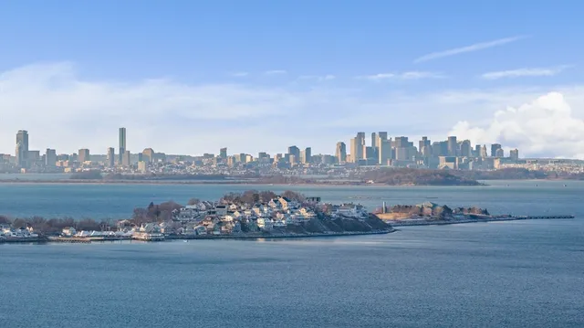 a kitchen with white cabinets and window