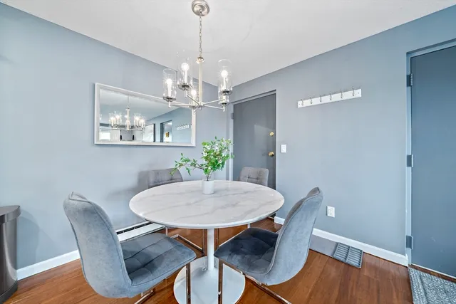 a view of a dining room with furniture wooden floor and chandelier