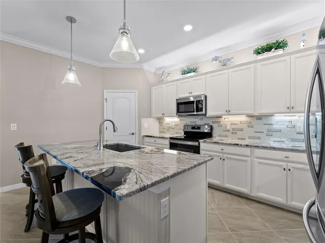 a view of a bedroom with a bed and wooden floor