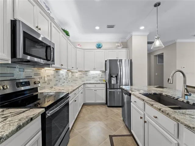 a bathroom with a granite countertop sink a toilet and bathtub