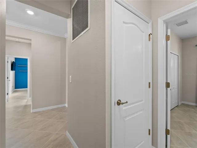 a view of a patio with lawn chairs floor to ceiling window and wooden floor