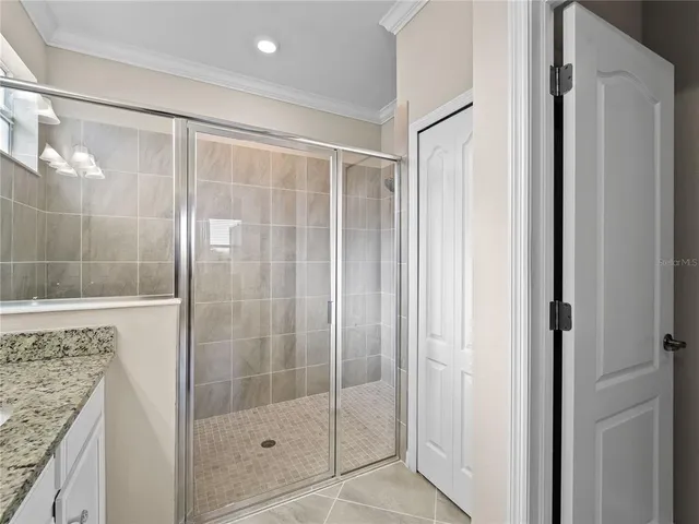 a view of a house with a big yard plants and large trees