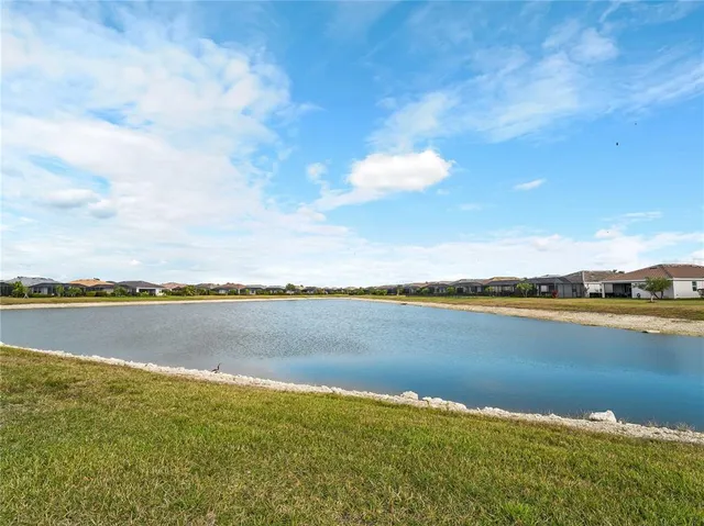 an aerial view of a house with garden space and ocean view
