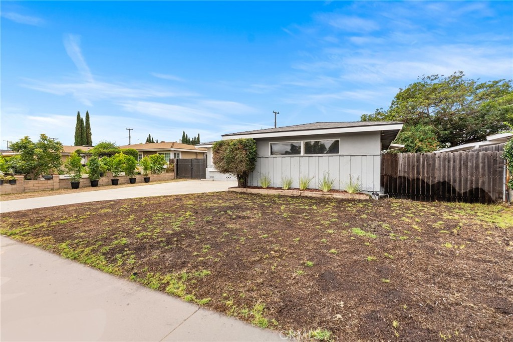 13361 Roxey Drive Garden Grove, CA 92843 - Photo 27 of 31 a front view of a house with a yard and garage