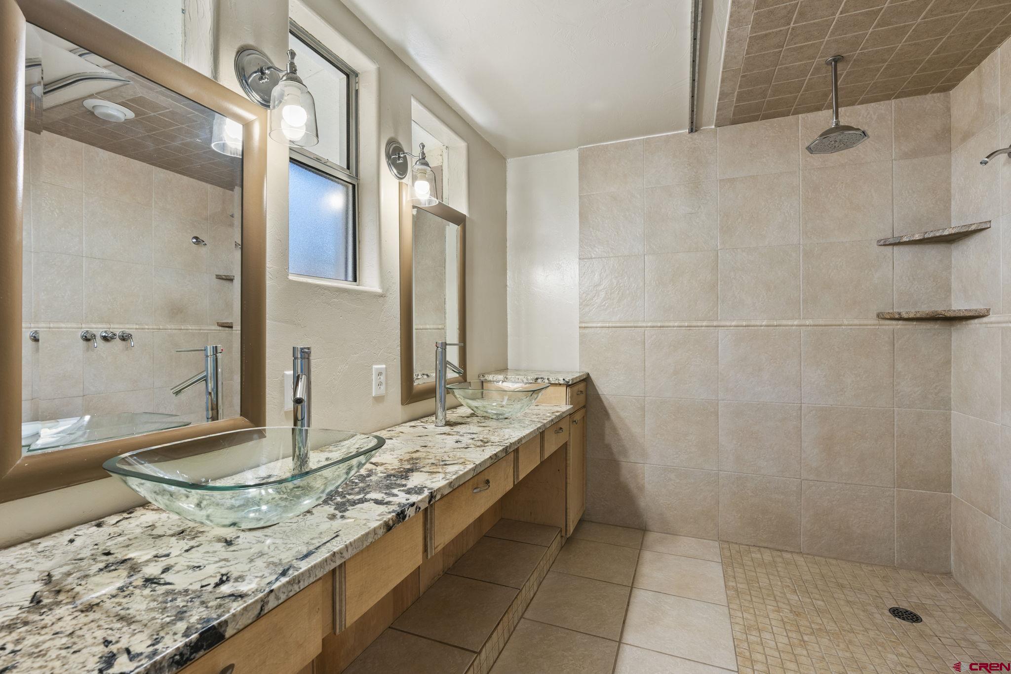486 South Church Street Bayfield, CO 81122 - Photo 11 of 32 a bathroom with a granite countertop sink and a mirror