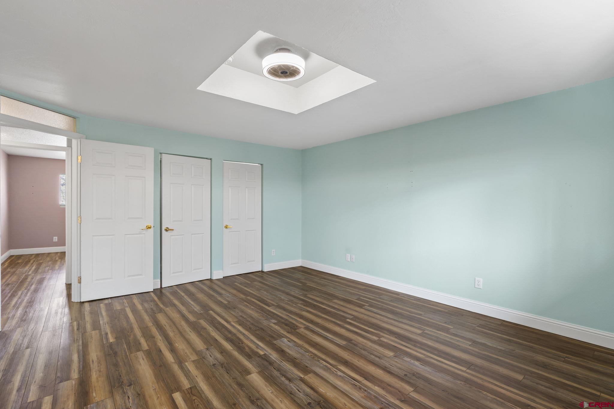 486 South Church Street Bayfield, CO 81122 - Photo 13 of 32 an empty room with wooden floor and windows