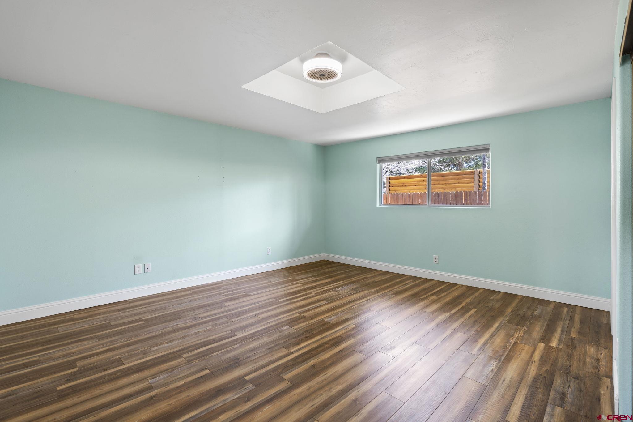 486 South Church Street Bayfield, CO 81122 - Photo 14 of 32 an empty room with wooden floor and windows