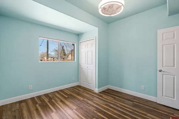 a view of room with window and wooden floor