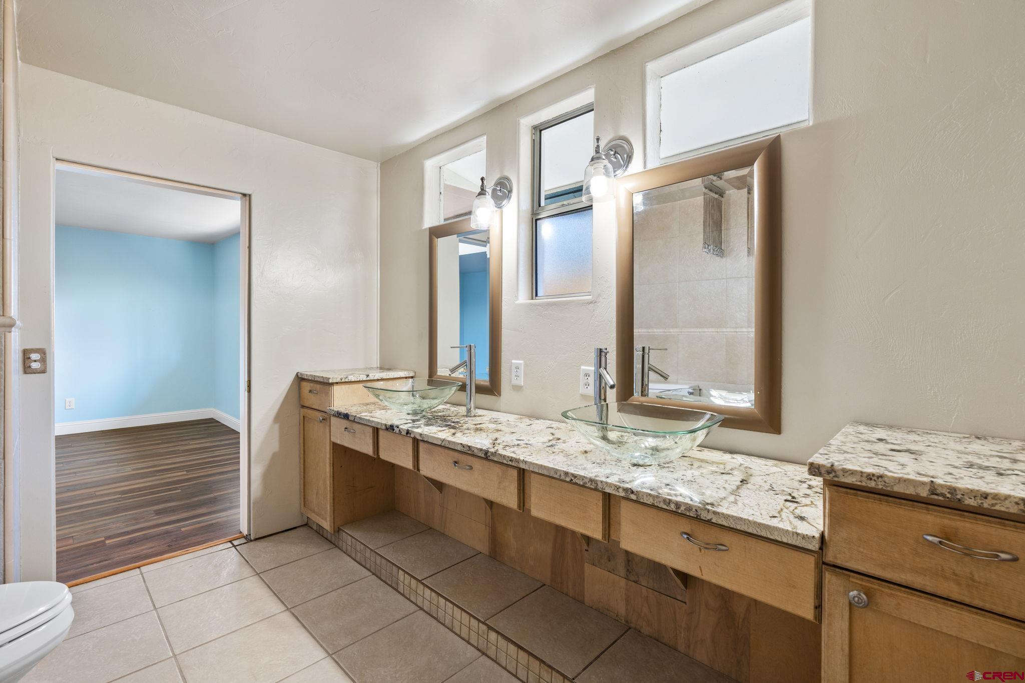 486 South Church Street Bayfield, CO 81122 - Photo 16 of 32 a bathroom with a granite countertop sink and a mirror