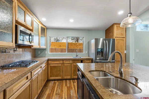 a kitchen that has a sink cabinets counter space and stainless steel appliances
