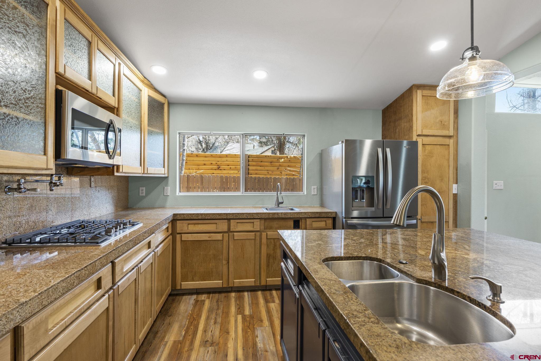 486 South Church Street Bayfield, CO 81122 - Photo 4 of 32 a kitchen that has a sink cabinets counter space and stainless steel appliances