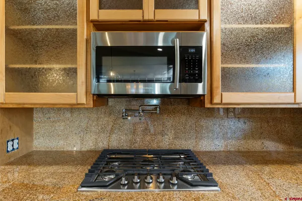 a kitchen with a stove and a microwave