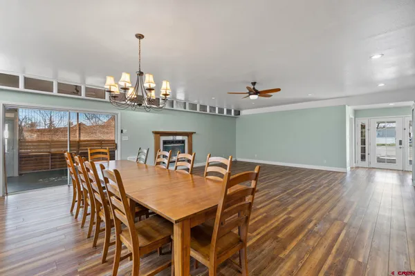 a view of a dining room with furniture wooden floor and chandelier