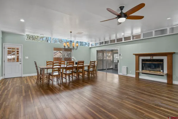 a view of a dining room with furniture and wooden floor