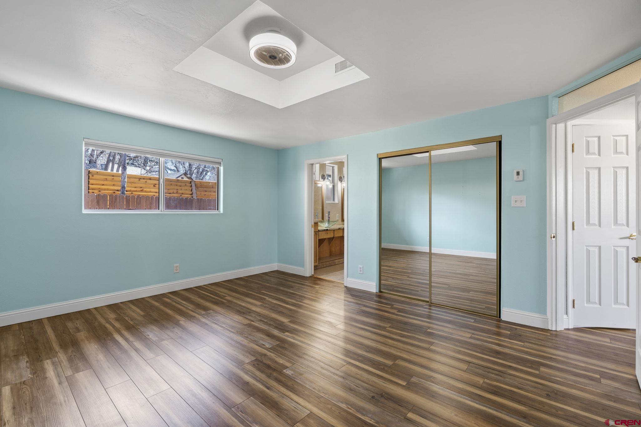 486 South Church Street Bayfield, CO 81122 - Photo 10 of 32 an empty room with wooden floor and windows